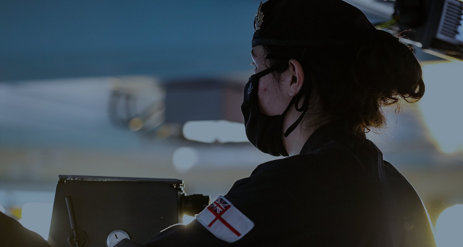 Naval servicewoman looks onwards on ship